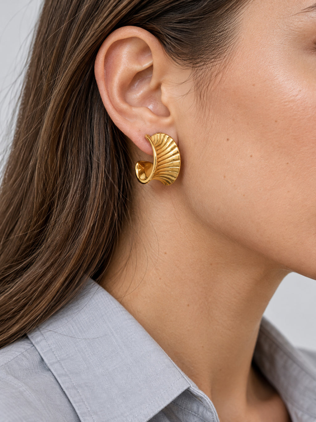 Cleo Huggie Earrings — worn view
