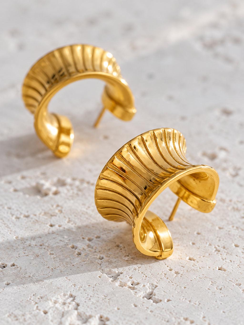 Cleo Huggie Earrings — detail view