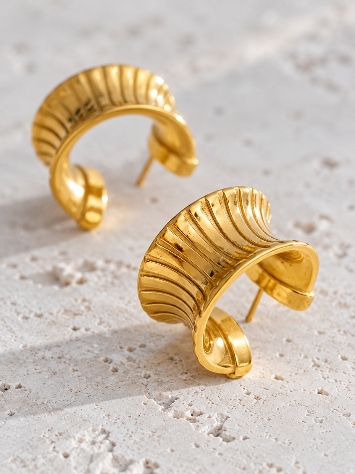 Cleo Huggie Earrings — detail view