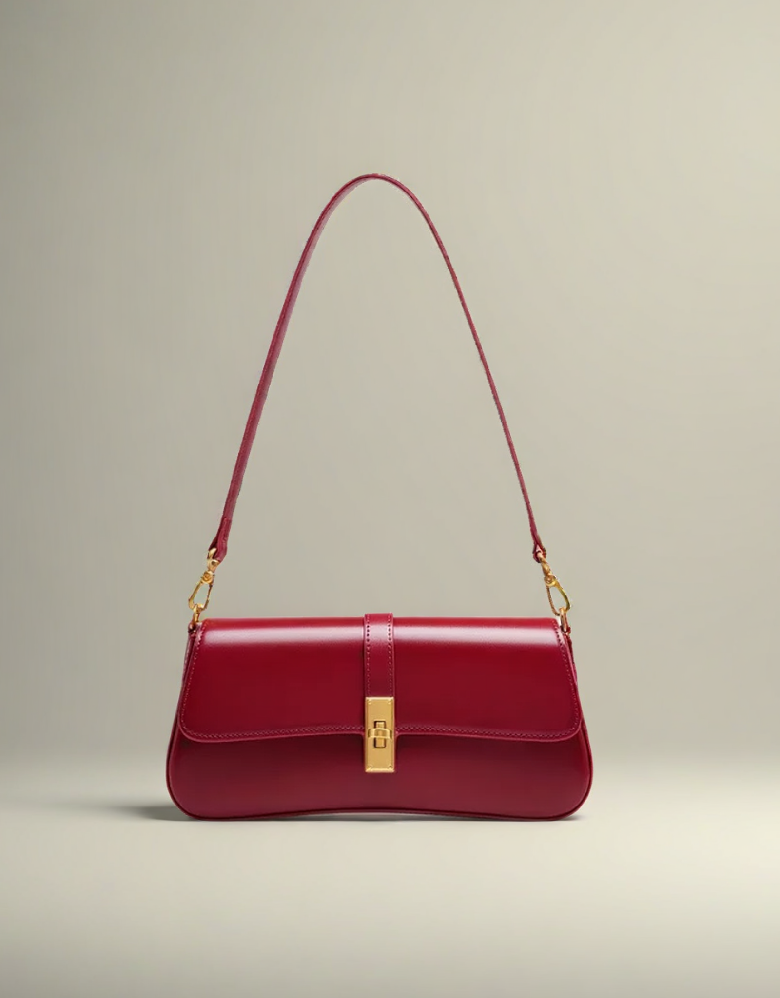Sac baguette en cuir rouge avec bandoulière élégante et fermeture dorée